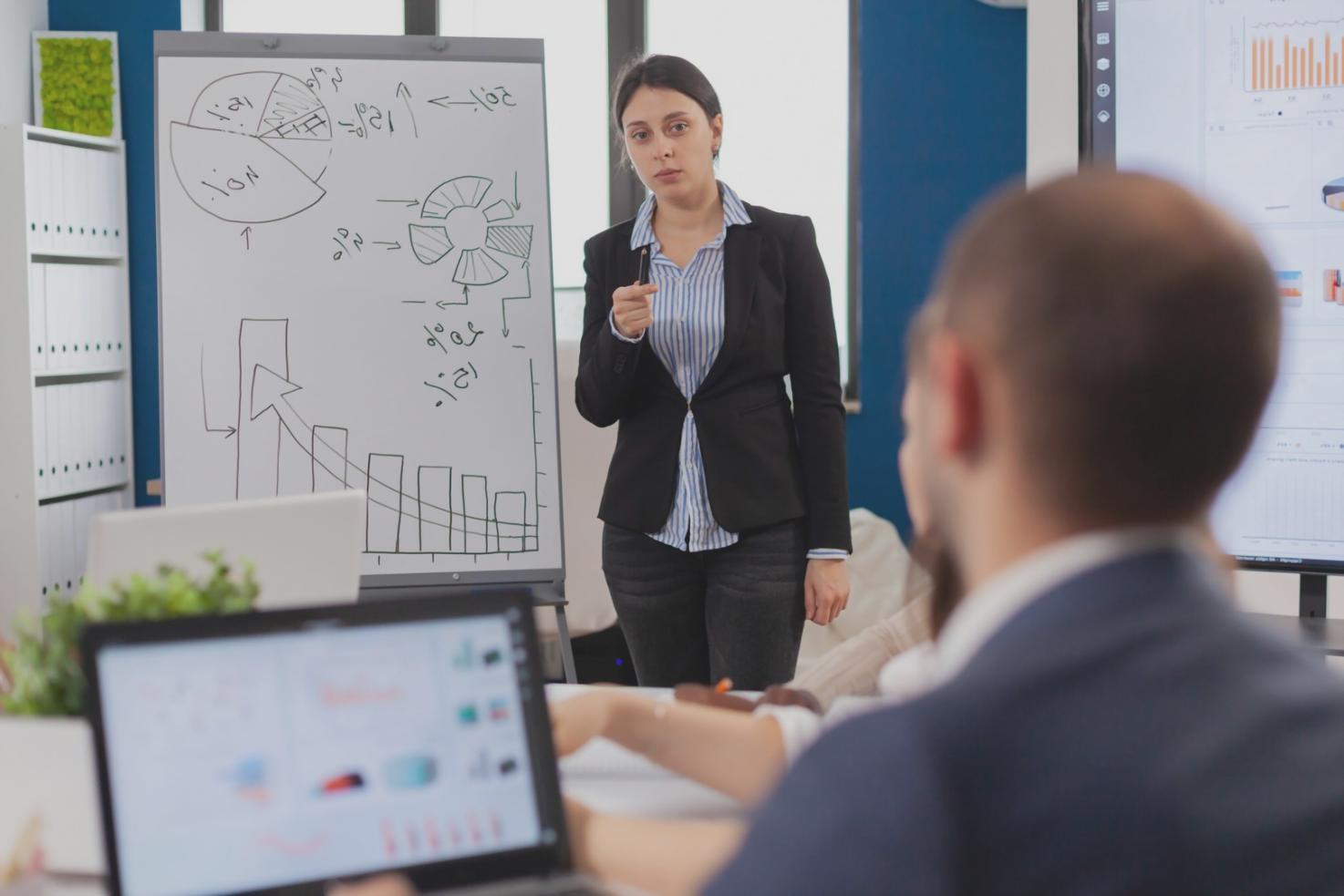 Financial planning professionals reviewing documents and charts in modern Australian office setting